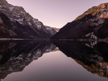 Scenic view of lake and mountains against clear sky