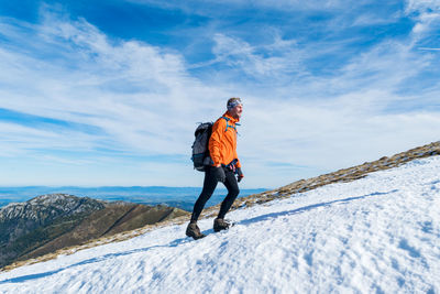 Man standing on snow against mountain