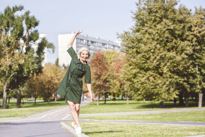 Smiling woman walking on edge of street in city