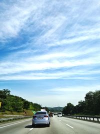 Cars on road against sky