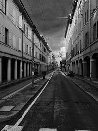 Empty road in city against sky