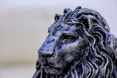 Close-up of lion statue against sky