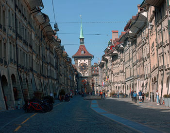 Group of people on street amidst buildings in city