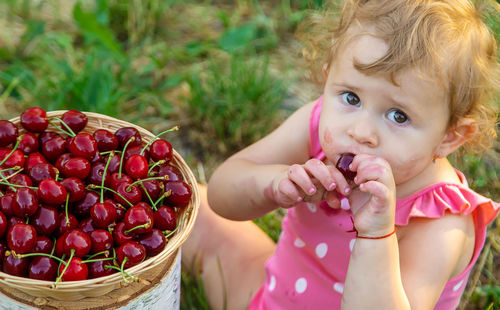 Laughing girl eating berries