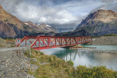 Bridge over mountains against sky