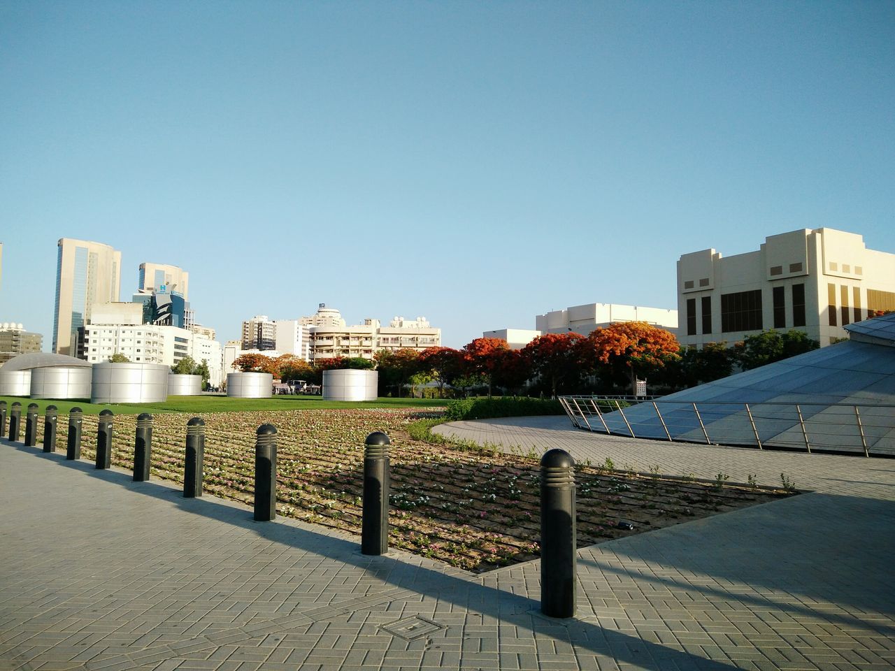 architecture, building exterior, built structure, clear sky, blue, city, day, outdoors, sky, building, cityscape, walkway, no people, city life