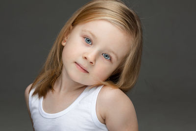 Portrait of smiling girl over black background