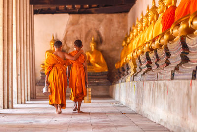 People in temple outside building