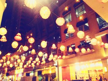 Low angle view of illuminated pendant lights hanging in restaurant