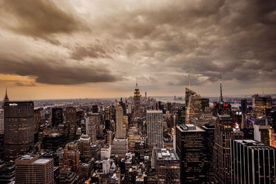 View of cityscape against cloudy sky