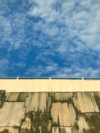 Low angle view of building against cloudy sky