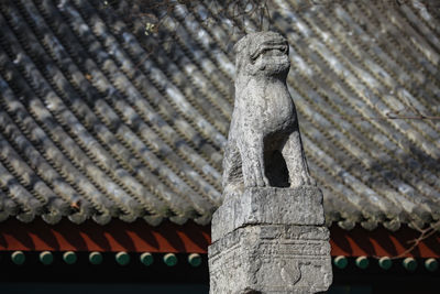 Low angle view of statue against building