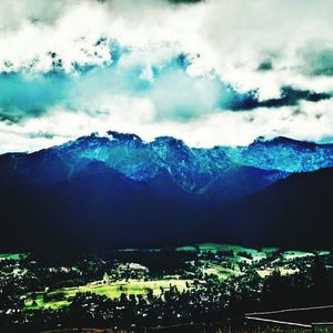 Scenic view of mountains against cloudy sky