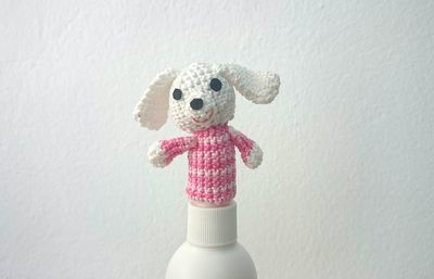 Close-up of handmade woolen toy against white wall