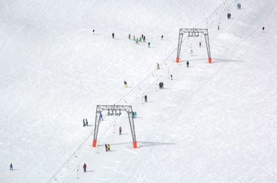 High angle view of people on snow covered landscape