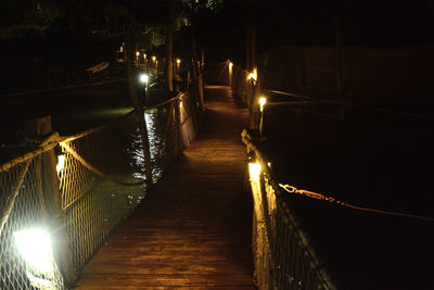 Illuminated bridge at night