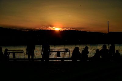 Silhouette of people at sunset