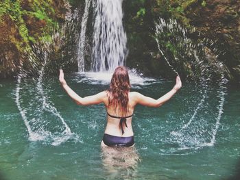 Rear view of woman in water