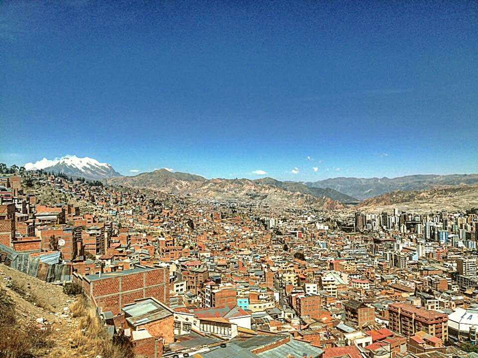 AERIAL VIEW OF CITYSCAPE AGAINST BLUE SKY