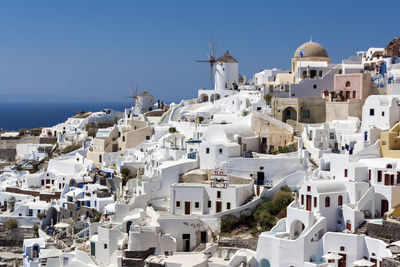 Buildings in city against blue sky