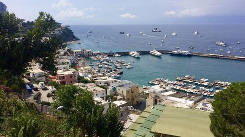 High angle view of buildings by sea against sky