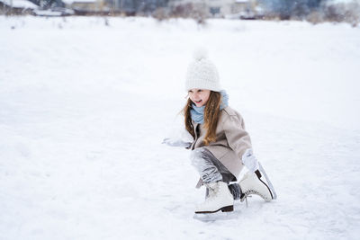 Full length of girl on snow covered field
