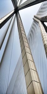 Low angle view of suspension bridge against sky