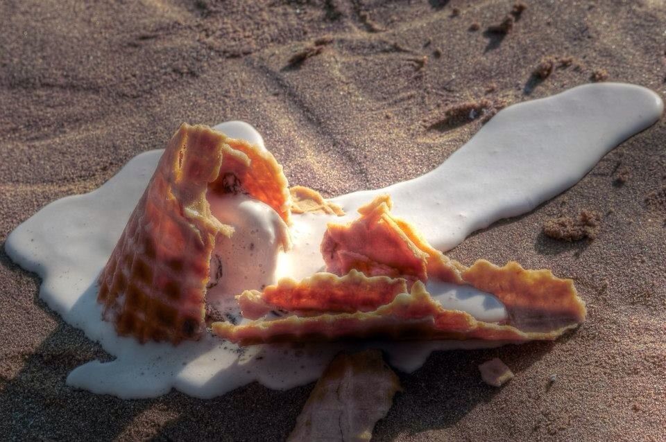 CLOSE-UP OF SANDWICH ON SAND