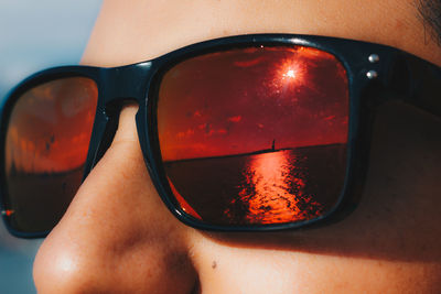 Reflection of woman on sunglasses