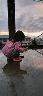 A little girl enjoying the after rain weather in terrace 