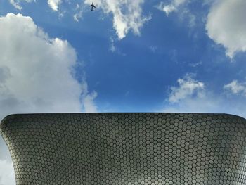 Low angle view of building against cloudy sky