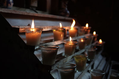 Illuminated tea light candles in church