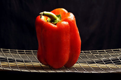 Close-up of red bell peppers against black background