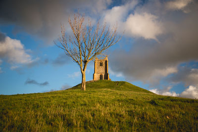 Built structure on field against sky