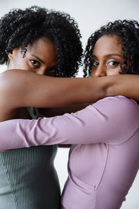 Portrait of two women of color hugging each other