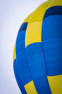 Low angle view of hot air balloon against blue sky