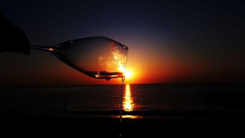 Sun shining over sea during sunset