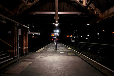 Empty railroad station platform at night