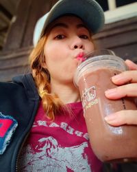 Portrait of woman drinking drink