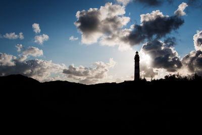 Low angle view of silhouette built structure against sky