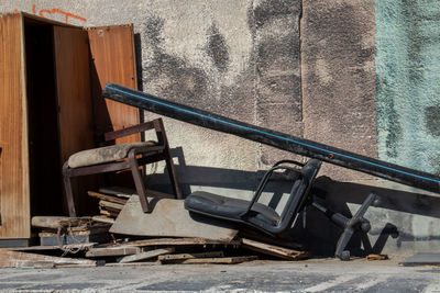 Abandoned shopping cart against wall in old building