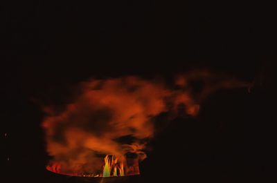 Silhouette people against sky at night