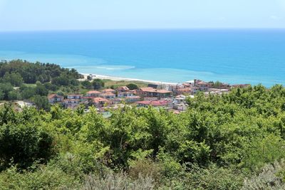 Scenic view of sea and buildings against sky