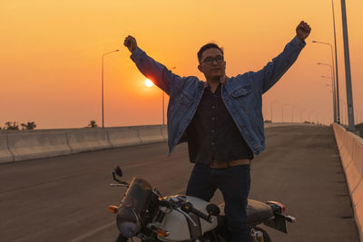 Young man riding big bike motocycle on asphalt high way against, motorbike man has freedom