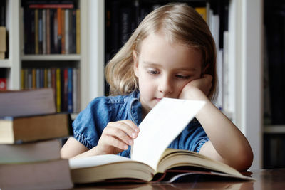 Portrait of happy woman sitting on book