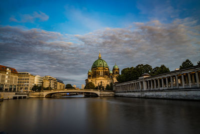 View of bridge over river against cloudy sky