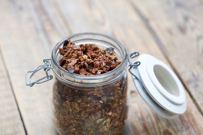 Close-up of oat flakes in jar on table