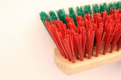 Close-up of colorful broom on white background