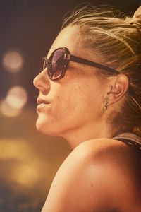 Close-up portrait of young woman wearing sunglasses