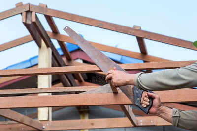 Low angle view of man working at construction site